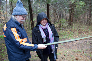 Herb E. Smith and Sandy Ballard examine a painted board from the wreckage of the farmhouse that has collapsed on the Arnow farm in Pulaski County, Ky. March 2011. Photo by Pat Arnow
