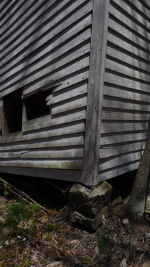 The schoolhouse is held up in the corners by rocks, and that's all. Photo by Pat Arnow, 2010. 