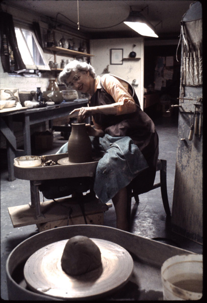 Edna Arnow in her basement studio at 2126 W. Touhy Ave., Chicago, in Rogers Park on the North Side of the city, throwing a pot. 1960. 