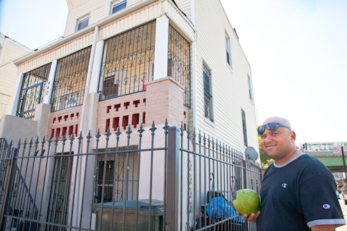 Manuel de la Cruz outside of the building where he lives around the corner from his "Tropicales Batidas" stand. Photo by Pat Arnow