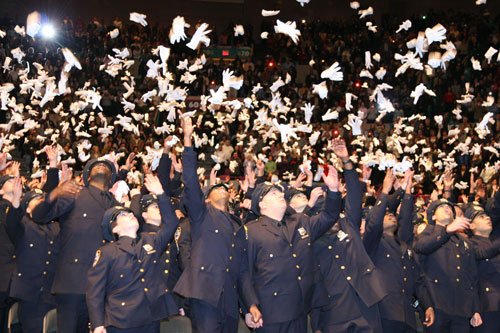 TAKING THE GLOVES OFF: The city's newest cops toss their gloves in the air to mark their graduation from the Police Academy during Dec. 26 ceremonies at Madison Square Garden. (12.06) I was proud of this picture. (I took it with a 2002 model Leica digital that had a lag between pressing button and when the shutter actually opened. I caught it just right.)