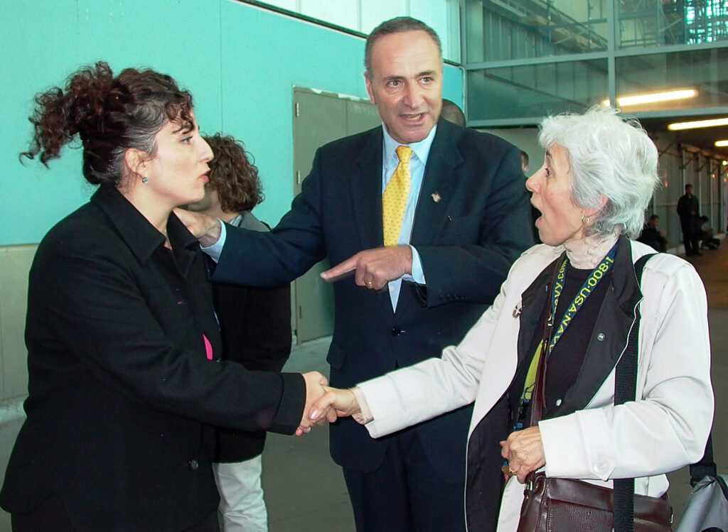 Senator Chuck Schumer campaigns by the Staten Island ferry in 2004 for Diane Savino, left, who was running as a newcomer for a Democratic seat in the New York State Senate for Staten Island and parts of Brooklyn. She won and became part of the Independent Democratic Caucus, which aligned with Republicans. She did support Marriage Equality. Despite her subsequent  record blocking good legislation, I always liked this photo. Everyone in it is dynamic and it tells the story. 